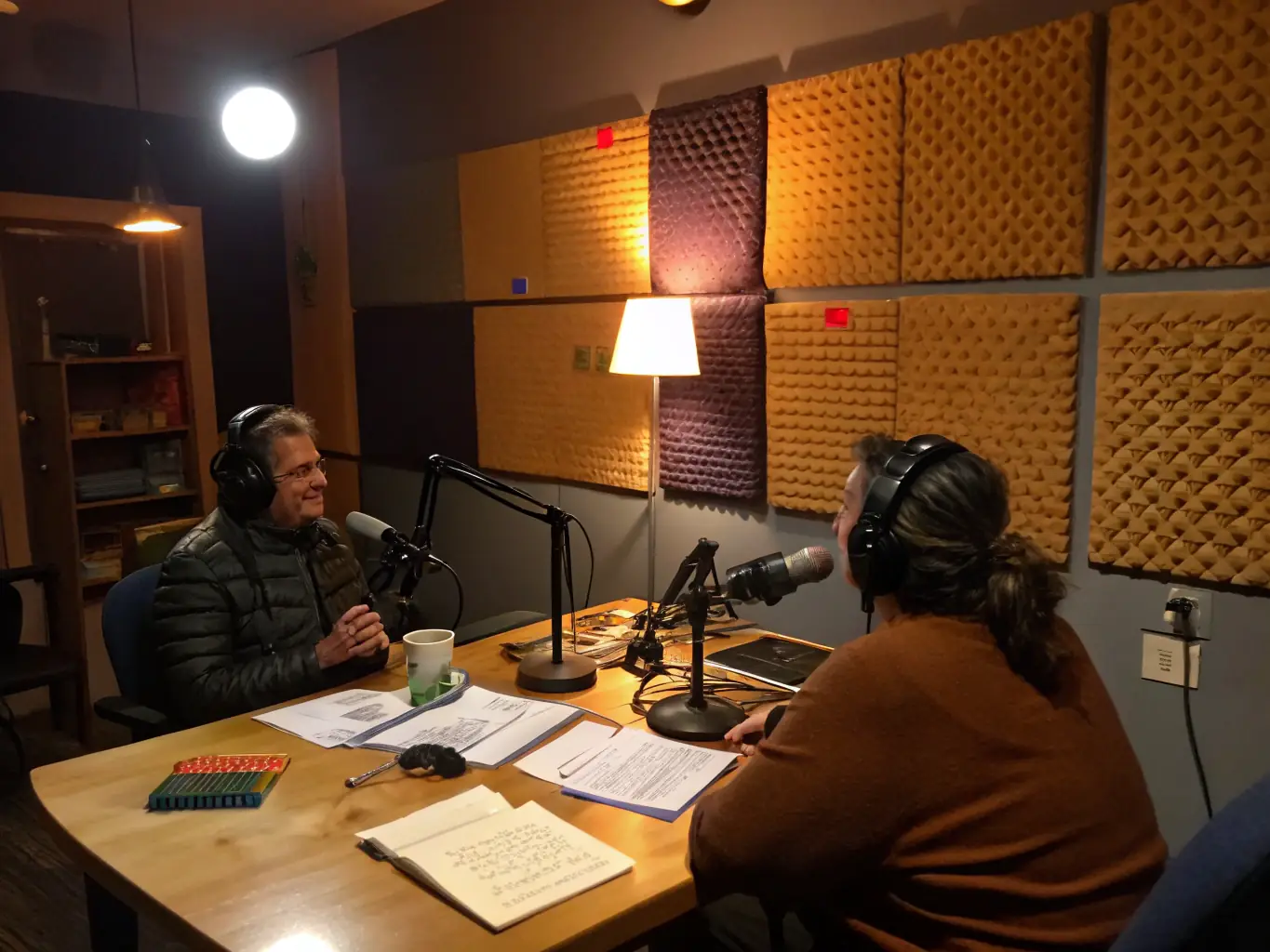An image of a podcast recording session, featuring two hosts discussing a topic of interest with microphones and recording equipment visible, representing the podcast offerings of MY Patriot Radio Network.